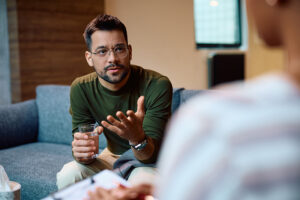 A man speaks in a session of outpatient trauma therapy during his addiction treatment program.