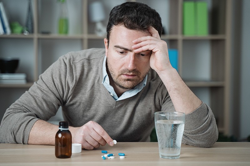 A man looks at his anxiety medication.