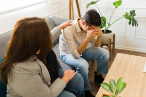 A man participates in therapy as part of an alcohol rehab program.