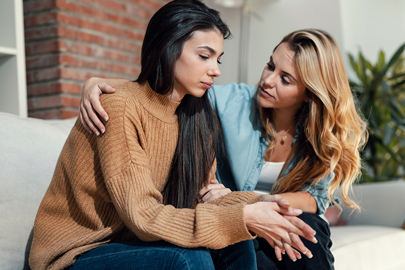 A woman talks to a family member about going to drug rehab.