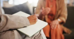 A provider discusses the difference between outpatient and inpatient treatment with a client.