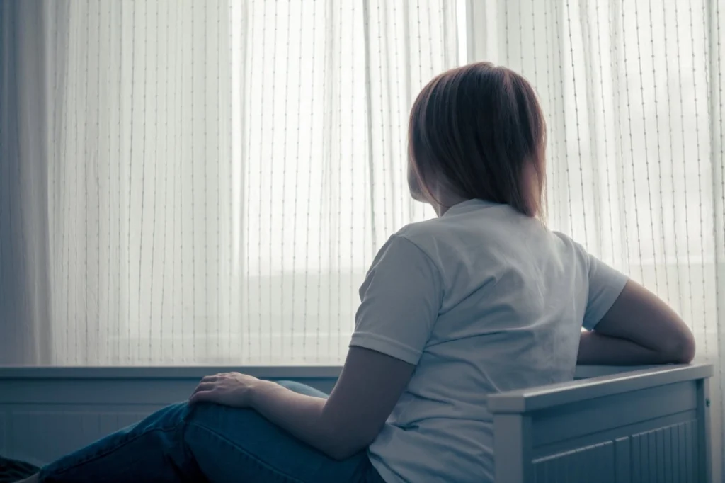 A person struggles with signs of heroin addiction.