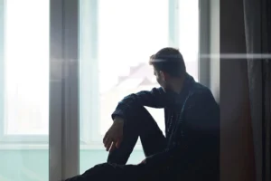 A person struggles with signs of heroin addiction.