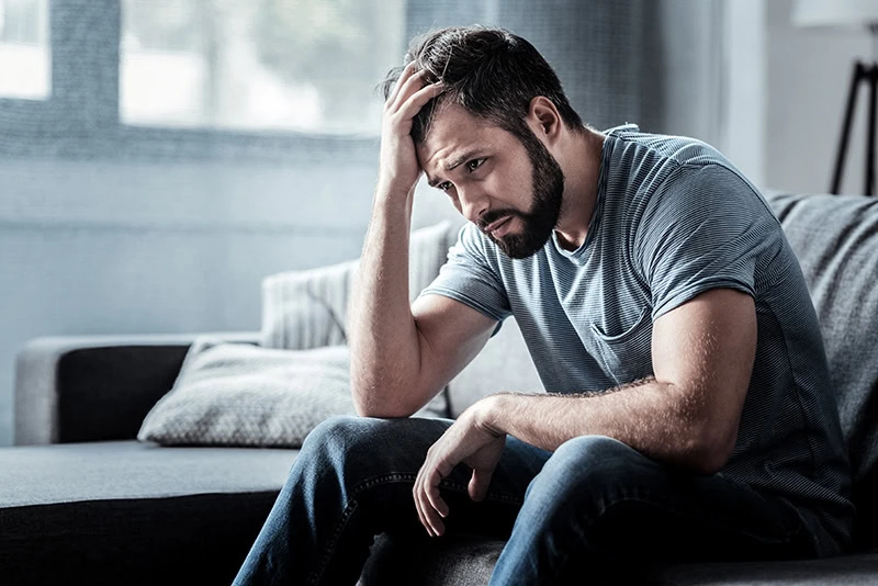 A man struggles with signs of cocaine addiction.