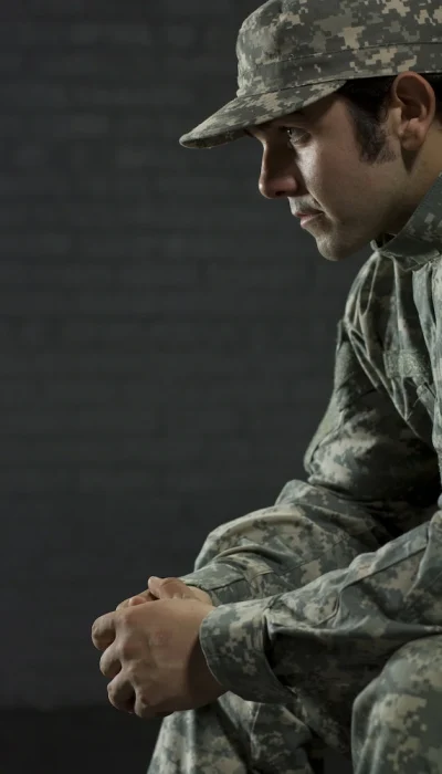 An active duty military member participates in therapy at an addiction treatment center.